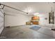 Large garage space with ample storage cabinets and door to house access at 10772 W Woodland Ave, Avondale, AZ 85323