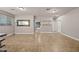 An airy living room boasts tile flooring and recessed lighting at 10772 W Woodland Ave, Avondale, AZ 85323