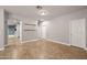 An open living room has tile flooring and neutral colored walls at 10772 W Woodland Ave, Avondale, AZ 85323