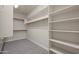 Walk-in closet with carpet and white shelving at 10772 W Woodland Ave, Avondale, AZ 85323