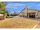 Backyard with lush lawn, swimming pool, covered patio, mature landscaping, and home exterior at 12125 N 91St Way, Scottsdale, AZ 85260