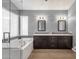Elegant bathroom featuring a double vanity, a large tub, and modern fixtures at 12125 N 91St Way, Scottsdale, AZ 85260
