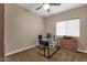 Bright bedroom with a ceiling fan, a modern desk, and a wall of windows at 12125 N 91St Way, Scottsdale, AZ 85260