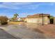 Wide driveway leading to a three-car garage, complemented by a basketball hoop at 12125 N 91St Way, Scottsdale, AZ 85260