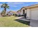 Beige single-Gathering home featuring a well-manicured lawn, three-car garage, and desert landscaping at 12125 N 91St Way, Scottsdale, AZ 85260