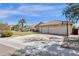Beige single-Gathering home with a three-car garage, a well-manicured lawn, and a basketball hoop at 12125 N 91St Way, Scottsdale, AZ 85260