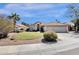 Charming beige single-Gathering home with a well-manicured lawn, three-car garage, and desert landscaping at 12125 N 91St Way, Scottsdale, AZ 85260