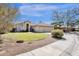 Charming beige single-Gathering home with a well-manicured lawn, three-car garage, and desert landscaping at 12125 N 91St Way, Scottsdale, AZ 85260