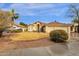 Inviting single-story home showcasing a manicured lawn, rock landscaping, and a convenient three-car garage at 12125 N 91St Way, Scottsdale, AZ 85260