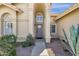 Close up of a beige single-Gathering home featuring a front entrance with an arched alcove and desert landscaping at 12125 N 91St Way, Scottsdale, AZ 85260