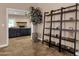 Hallway with decorative shelving, tile flooring, and easy access to the living area that features a fireplace at 12125 N 91St Way, Scottsdale, AZ 85260