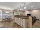Open kitchen features a breakfast bar with stone accents, granite countertop, and modern pendant lighting at 12125 N 91St Way, Scottsdale, AZ 85260