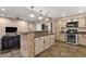 Bright kitchen area shows the breakfast bar, a suite of appliances, and white cabinets at 12125 N 91St Way, Scottsdale, AZ 85260