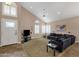 Cozy living room with carpet, a plush sectional sofa, neutral paint, and lots of natural light from shuttered windows at 12125 N 91St Way, Scottsdale, AZ 85260