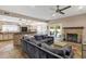 Spacious living room with fireplace, bar with stone facade, access to the backyard, and lots of natural light at 12125 N 91St Way, Scottsdale, AZ 85260