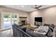 Comfortable living room with stone fireplace, sliding glass door to outdoor space and lots of natural light at 12125 N 91St Way, Scottsdale, AZ 85260