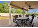 Covered patio with table and chairs overlooking the pool and backyard at 12125 N 91St Way, Scottsdale, AZ 85260