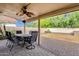 Covered patio with brick pavers, ceiling fan and outdoor furniture in a well maintained yard at 12125 N 91St Way, Scottsdale, AZ 85260