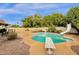 Swimming pool with diving board, slide, rock features, and mature landscaping at 12125 N 91St Way, Scottsdale, AZ 85260