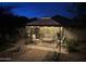 Backyard gazebo illuminated at night, featuring a cozy seating area and manicured landscaping at 12508 W Highland Ave, Litchfield Park, AZ 85340