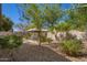 Serene backyard featuring a gazebo with seating, amidst lush landscaping and gravel ground cover at 12508 W Highland Ave, Litchfield Park, AZ 85340