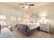 Cozy bedroom with a ceiling fan, carpeted floors, and a large window with natural light at 12508 W Highland Ave, Litchfield Park, AZ 85340
