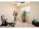 Bright, carpeted bedroom featuring fitness equipment and a view through a sunlit window at 12508 W Highland Ave, Litchfield Park, AZ 85340