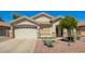 Charming single-story home featuring a two-car garage and xeriscaped front yard at 12508 W Highland Ave, Litchfield Park, AZ 85340