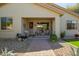 Inviting covered front porch with a seating area and landscaped surroundings at 12508 W Highland Ave, Litchfield Park, AZ 85340