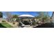 Backyard gazebo with outdoor seating area, surrounded by desert landscaping and a manicured lawn at 12508 W Highland Ave, Litchfield Park, AZ 85340
