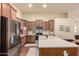 Well-equipped kitchen features an island with a sink, stainless steel appliances, and ample counter space at 12508 W Highland Ave, Litchfield Park, AZ 85340