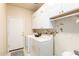 Well-equipped laundry room with white cabinetry and modern appliances at 12508 W Highland Ave, Litchfield Park, AZ 85340
