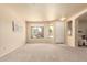 Spacious living room with ample natural light, neutral decor and seamless flow at 12508 W Highland Ave, Litchfield Park, AZ 85340