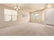 Bright and airy living room featuring large windows, neutral walls, and plush carpeting at 12508 W Highland Ave, Litchfield Park, AZ 85340