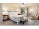 Comfortable main bedroom boasts a ceiling fan, carpet floors, and bright, natural light at 12508 W Highland Ave, Litchfield Park, AZ 85340