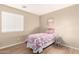 Cozy bedroom with bright floral decor, a bedside table, and window at 12720 W Mandalay Ln, El Mirage, AZ 85335