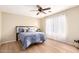 Comfortable bedroom with wood-like flooring, a ceiling fan, and a serene atmosphere for restful nights at 12720 W Mandalay Ln, El Mirage, AZ 85335