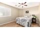 Cozy bedroom with ceiling fan, window with blinds, and stylish decor at 12720 W Mandalay Ln, El Mirage, AZ 85335