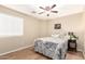 Bedroom features a ceiling fan, window, and neutral wall decor at 12720 W Mandalay Ln, El Mirage, AZ 85335