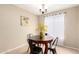 Cozy dining area with a round table, chandelier lighting, and decorative artwork at 12720 W Mandalay Ln, El Mirage, AZ 85335