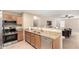 Modern kitchen with granite countertops, stainless steel appliances, and an open layout connecting to the living area at 12720 W Mandalay Ln, El Mirage, AZ 85335