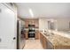 Well-equipped kitchen featuring stainless steel appliances, granite countertops, and a convenient breakfast bar at 12720 W Mandalay Ln, El Mirage, AZ 85335