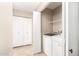 Well-equipped laundry room with modern washer, dryer, and storage at 12720 W Mandalay Ln, El Mirage, AZ 85335