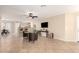 Open-concept living area with tile flooring and ceiling fan connecting to the adjacent kitchen at 12720 W Mandalay Ln, El Mirage, AZ 85335