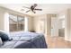 Serene main bedroom boasting wood-like floors, natural light, and an en-suite bathroom for added privacy at 12720 W Mandalay Ln, El Mirage, AZ 85335