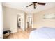 Bright bedroom boasts wood floors, a ceiling fan, and ensuite bath access at 12720 W Mandalay Ln, El Mirage, AZ 85335