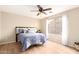 Comfortable bedroom with ample natural light, wood floors, and a ceiling fan at 12720 W Mandalay Ln, El Mirage, AZ 85335