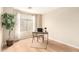 Bright home office featuring a large window, desk, and neutral decor at 12720 W Mandalay Ln, El Mirage, AZ 85335