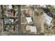 Aerial view of distinctive homes including triangular modern residence, set among neighborhood and desert landscape at 1340 E Las Palmaritas Dr, Phoenix, AZ 85020