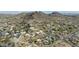 Vast aerial view captures neighborhood nestled amid desert terrain, backed by a scenic mountain range backdrop at 1340 E Las Palmaritas Dr, Phoenix, AZ 85020